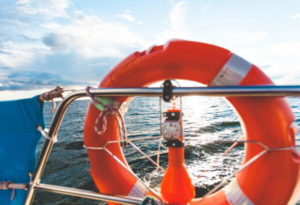 An orange life saver on the front of a boat.