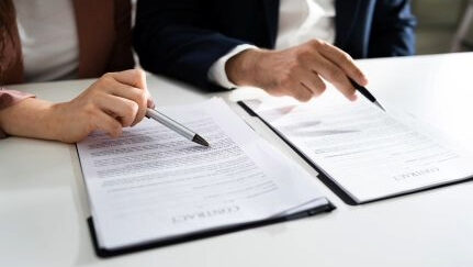 Two people review documents together.