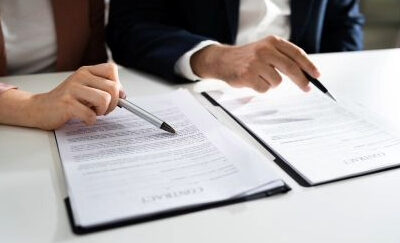 Two people review documents together.