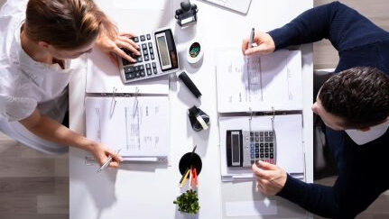 Two people calculate the costs.