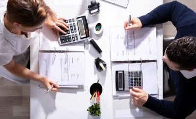 Two people calculate the costs.