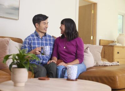couple sitting on couch smiling
