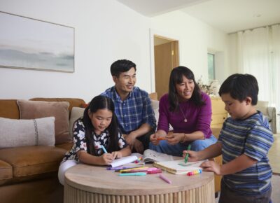 family coloring together and smiling