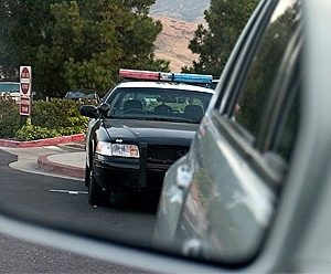 a cop car in a side view mirror of a car
