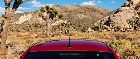 a roof of a car in front of a desert background